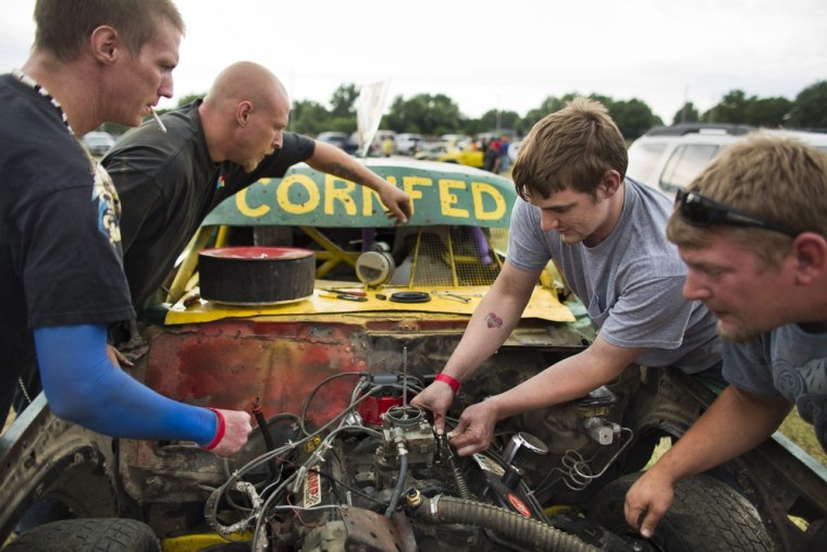 Left to right: Chris Zweck, Roger Zweck, Aaron Lemon and Josh Roosa ready their car, which they gave the name 'Cornfed,' before the start of figure 8 races at the Hardin County Fair in Eldora on July 13.