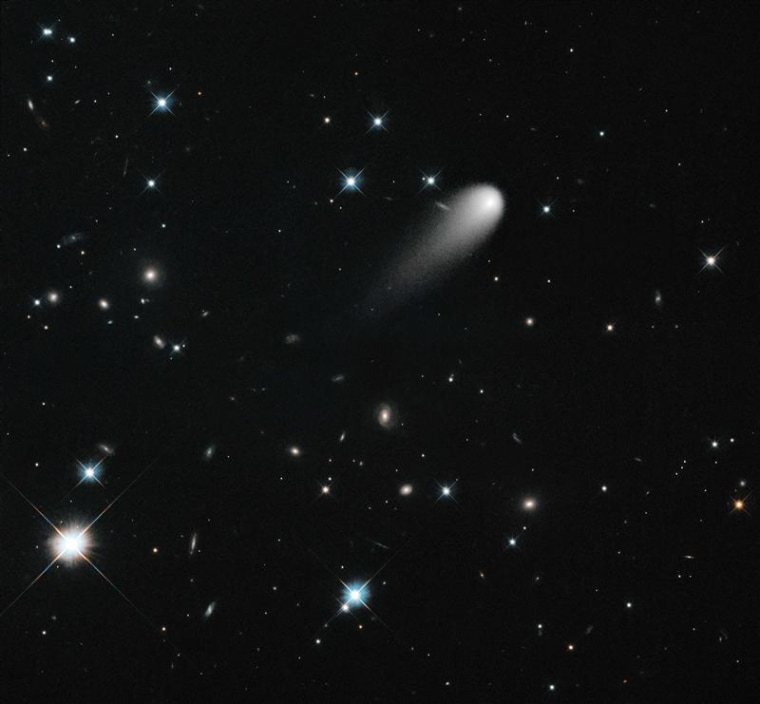 The sun-approaching Comet ISON floats against a seemingly infinite backdrop of numerous galaxies and a handful of foreground stars in this April 2013 ...