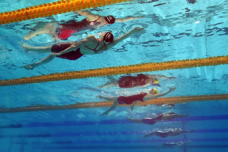 Missy Franklin of the United States, left, and Emily Seebohm of Australia, center, compete in the Women's 100m backstroke final.