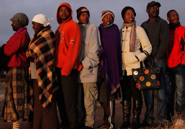 Residents of the high-density suburb of Mbare in the Zimbabwean capital Harare line up in the early hours to cast their ballots in presidential elections on July 31, 2013.