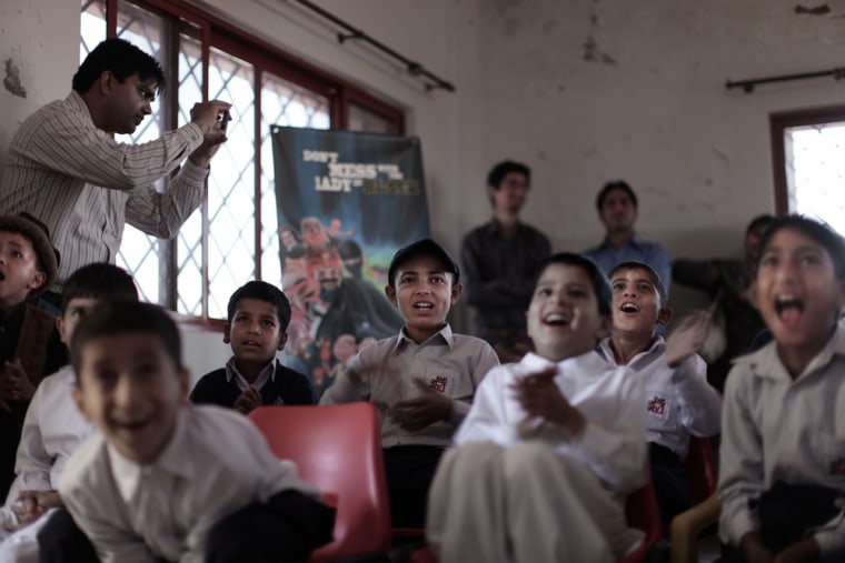 Pakistani orphans react while watching an early screening of the first episode of Burka Avenger animated series, at an orphanage on the outskirts of Islamabad, Pakistan on March 25, 2013.
