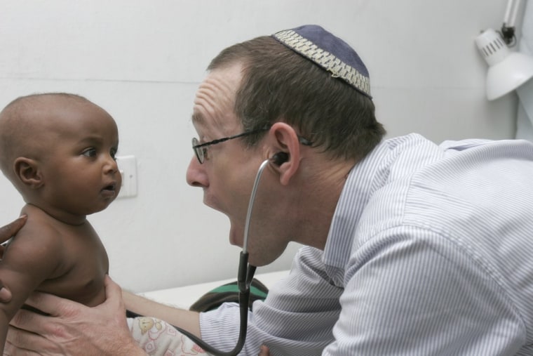 Dr. Rick Hodes, medical director of the American Jewish Joint Distribution Committee, examines a young patient at the Blue Nile Medical Clinic in Addis Ababa, Ethiopia.