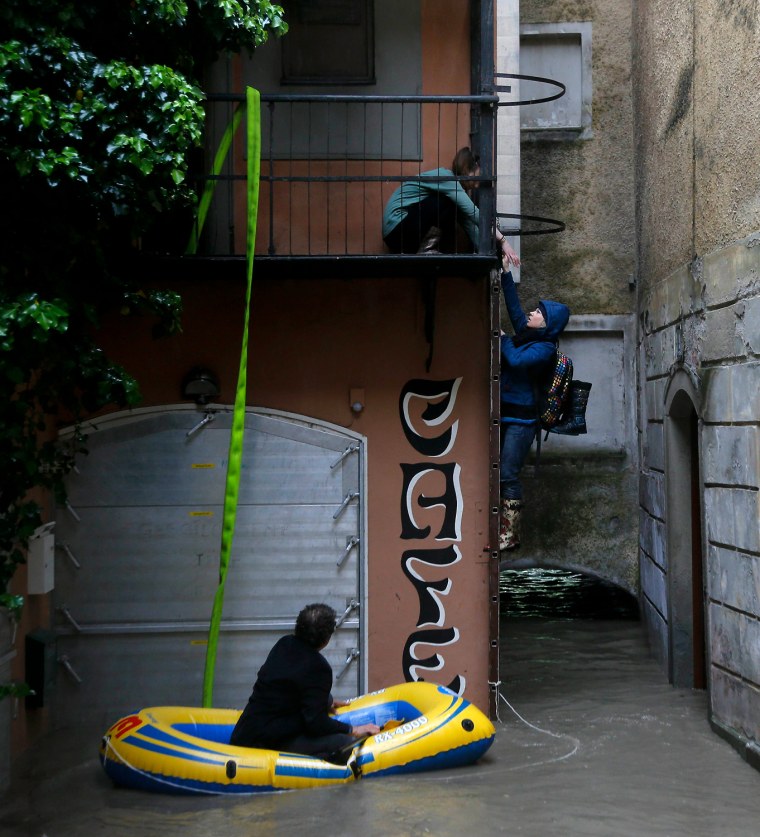 Residents use an inflatable boat to enter their flat on a flooded street after heavy rainfall in the small Austrian city of Steyr on Sunday.