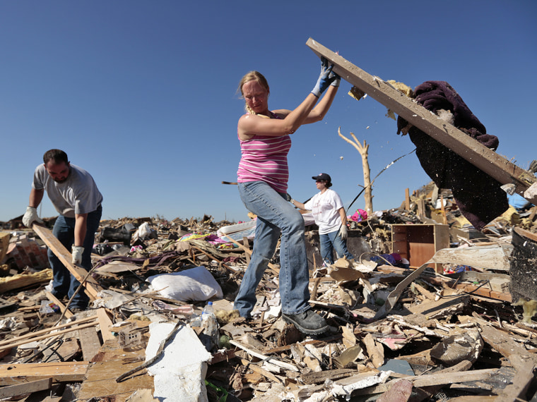 Thomas Trowbridge and his wife Kelcy salvage items from their house after a monster tornado struck Moore, Okla., on May 22. Within days, many officials spoke of the