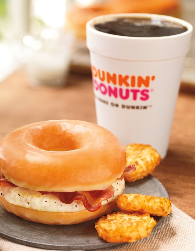 This photo provided by Dunkin' Brands, Inc., shows the company's glazed donut breakfast sandwich. Dunkin' Donuts is adding a doughnut breakfast sandwi...