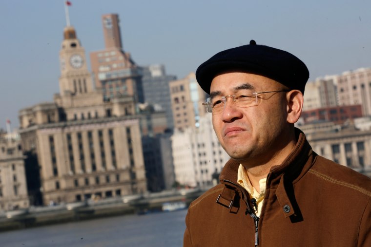 Chinese-born U.S. scientist Hu Zhicheng stands at the waterfront promenade along the Huangpu River in Shanghai, China. He was jailed for 17 months and then barred from leaving the country for another three years after a business rival accused him of stealing trade secrets.
