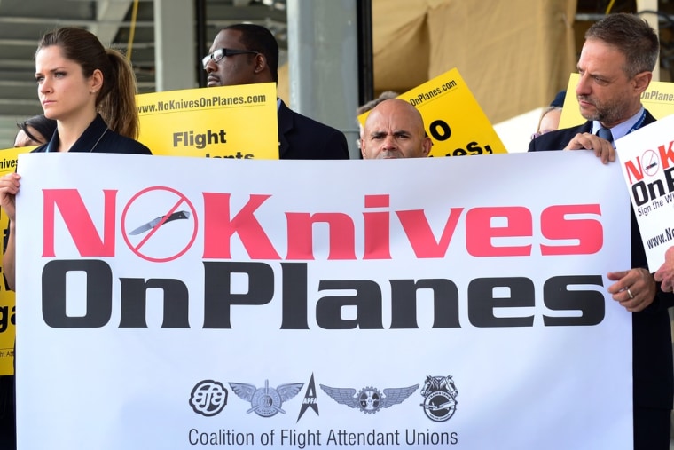 Flight attendants for U.S. airlines hold banners and placards while picketing at Los Angeles International Airport's departure level demanding that sm...