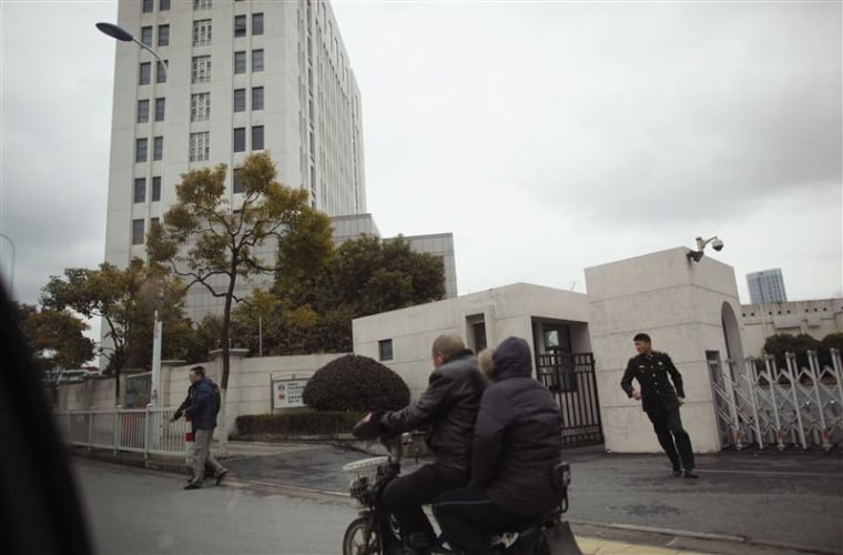 Motorcyclists ride past 'Unit 61398', a secretive Chinese military unit, in the outskirts of Shanghai February 19, 2013. The unit is believed to be be...