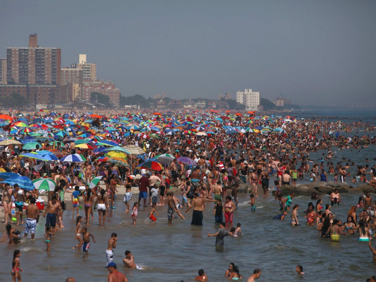 People crowd at the beach at Coney Island in Brooklyn, New York, on June 30, 2012, as heat waves and thunderstorms hit the eastern United States