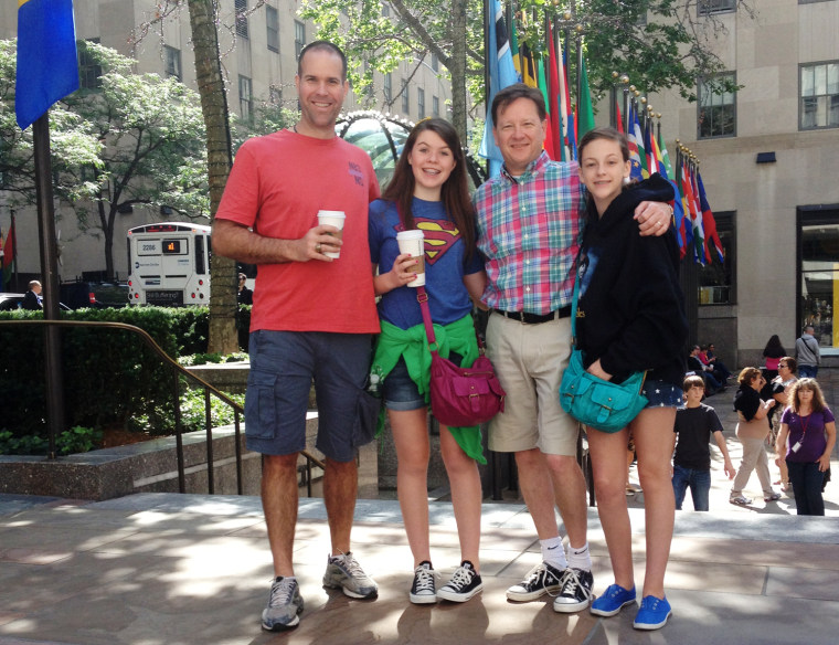 Randy Edwards, right, and Dwayne Dohmann, left, stand with their daughters on Rockefeller Plaza on Thursday. Edwards defended the government's collection of phone data, but Dohmann worried about an invasion of privacy.
