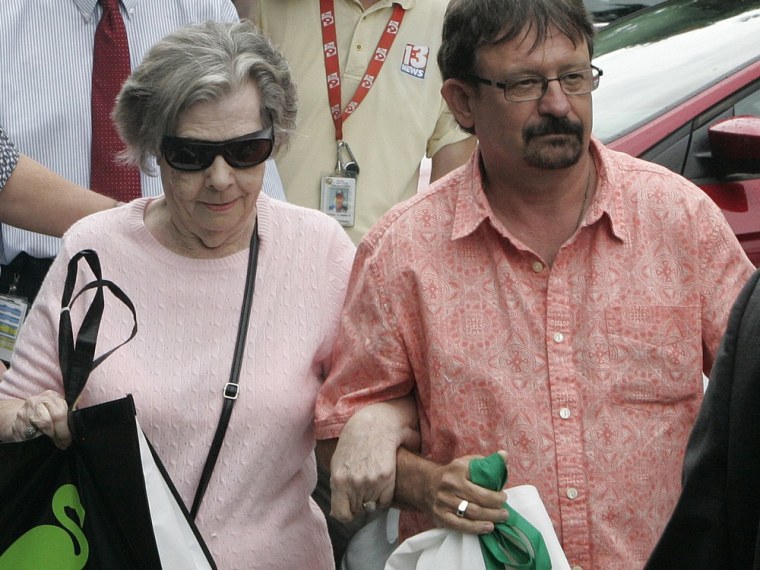 Powerball winner Gloria C. MacKenzie, 84, left, leaves the lottery office escorted by her son, Scott Mackenzie, after claiming a single lump-sum payment of about $370.9 million before taxes on June 5, in Tallahassee, Fla.