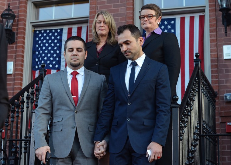 Kris Perry, back left, and Sandy Stier, and Jeff Zarrillo, front left, and Paul Katami, prepare to leave for the Supreme Court on March 26, 2013, in Washington.