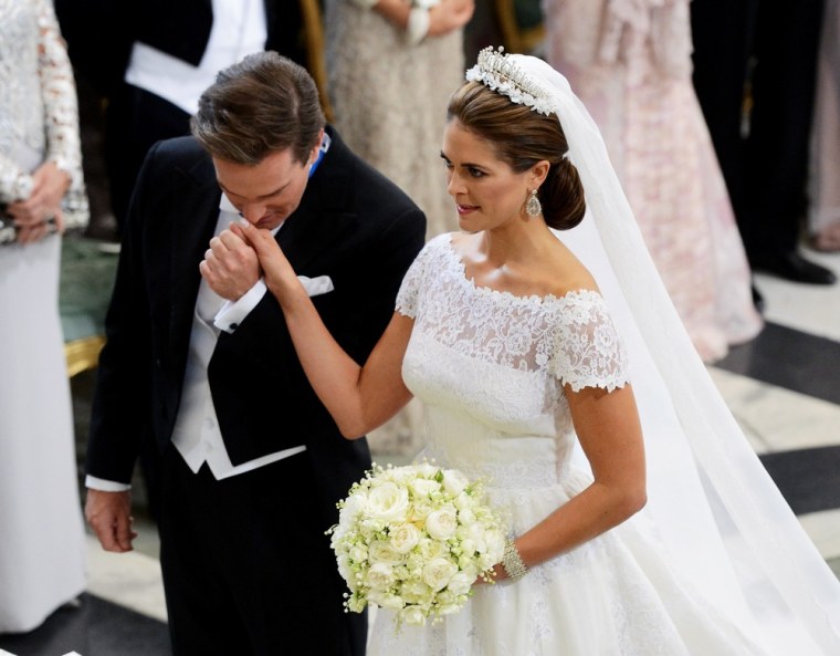 Christopher O'Neill kisses the hand of Princess Madeleine of Sweden at the alter in the Royal Chapel during their wedding ceremony in Stockholm.