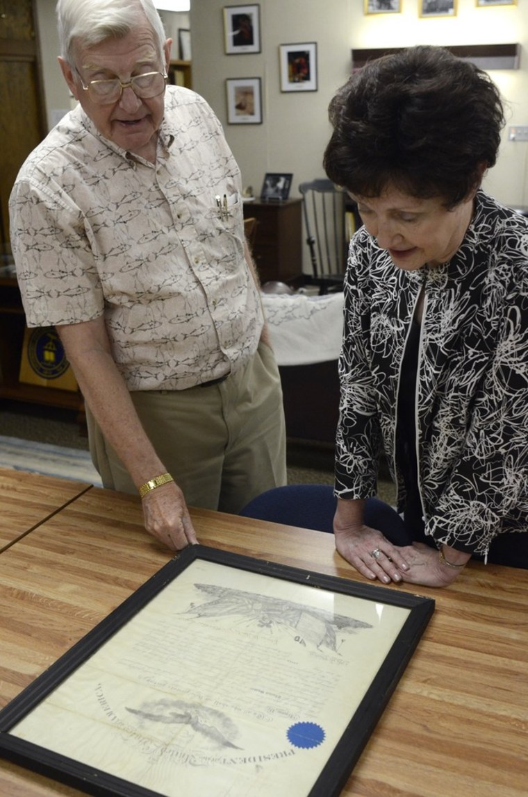 Lycoming College historian, John Piper, left, and Janet Hurlbert, dean and director of the school's Library, look over a certificate signed by Abraham Lincoln in the college archives in Williamsport, Pa.