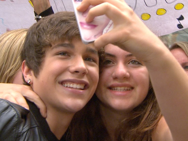 Mahone smiles for the camera with a fan.