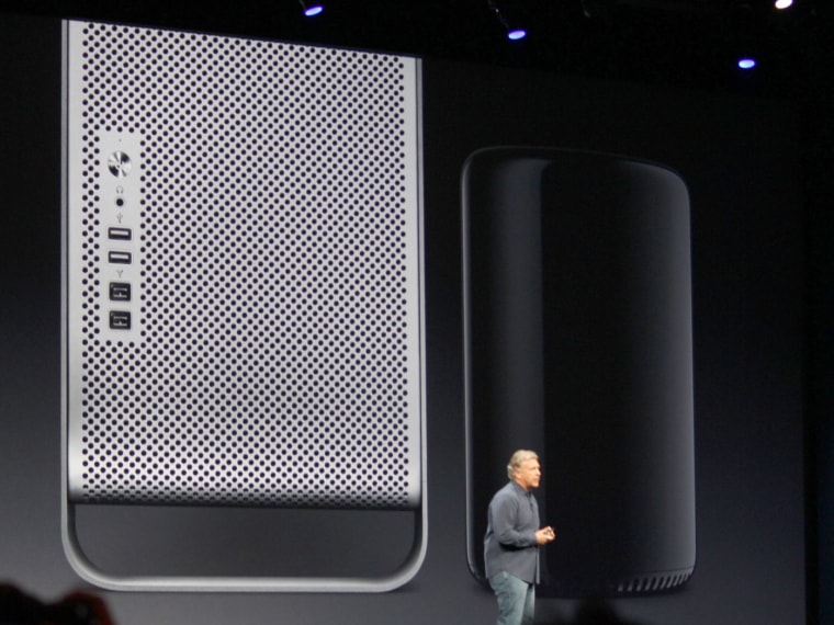 Apple's Phil Schiller demonstrating the size difference between the old Mac Pro (left) and the new one (right), due this fall.