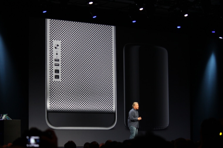 Phil Schiller shows the current Mac Pro, left, next to its tinier successor.