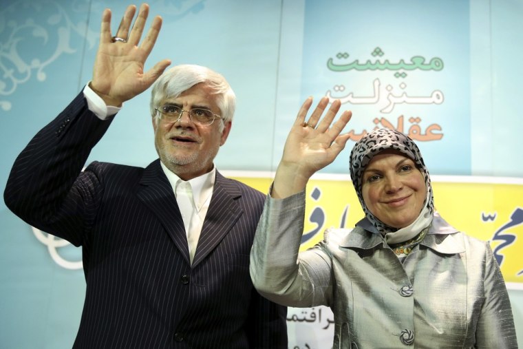 Mohammad Reza Aref and his wife, Hamideh Moravej Farshi, wave to the audience after announcing his candidacy in the presidential election. He withdrew from the race on Tuesday.