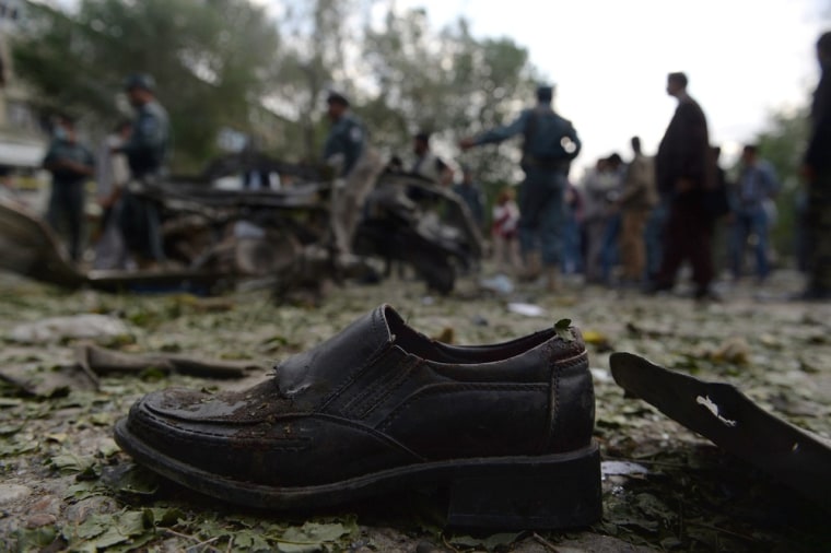 A victim's shoe lies on the ground as Afghan police secure the site of a suicide attack in Kabul on June 11.