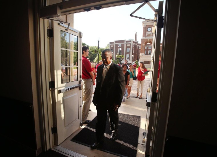Darrell Hood, son of James Hood, enters Foster Auditorium for