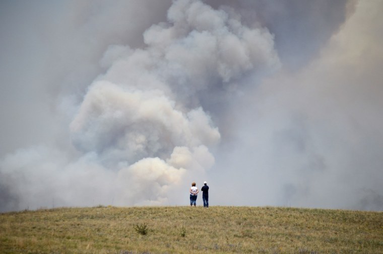 Chris and Christine Walker watch the Black Forest Fire gain steam as it burns out of control for a second straight day near Colorado Springs on June 12, 2013. The Walkers live nearby and were under pre-evacuation orders.