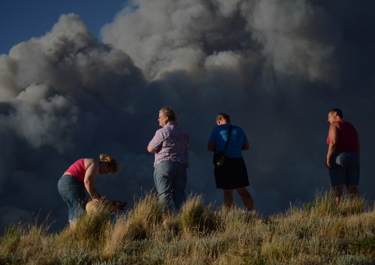 Residents watch as the Black Forest Fire burns northeast of Colorado Springs on June 11, 2013.