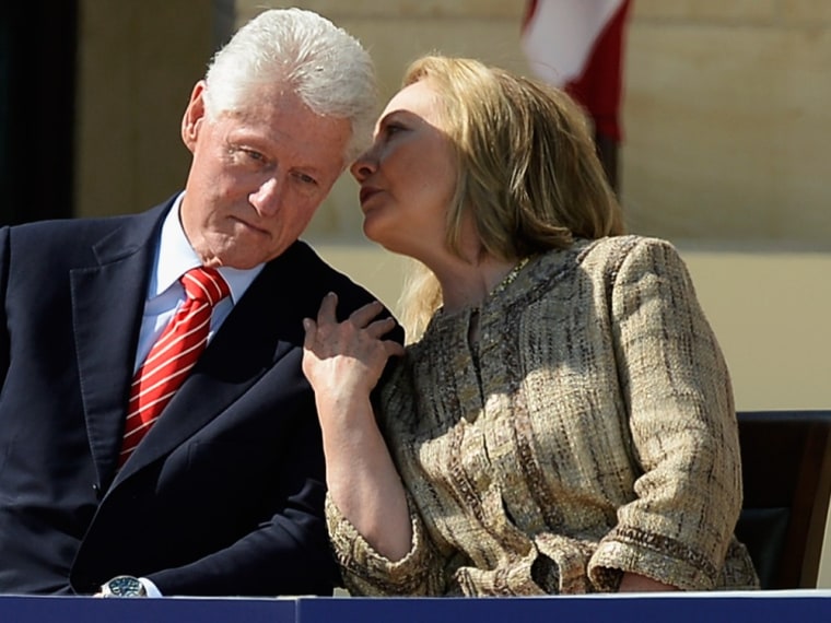 Former first lady and former Secretary of State Hillary Rodham Clinton speaks with her husband former president Bill Clinton as they attend the opening ceremony of the George W. Bush Presidential Center April 25, 2013 in Dallas, Texas.