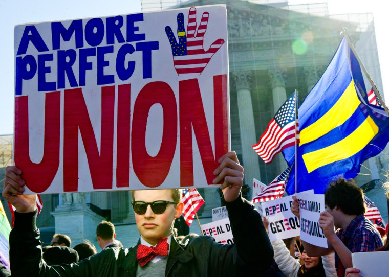 A gay marriage supporter holds a placard at the US Supreme Court on March 27, 2013 in Washington, DC.