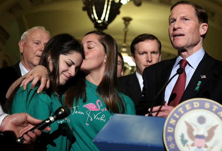 U.S. Sen. Richard Blumenthal (D-CT), right, speaks as Sandy Hook victim Dawn Hochsprung's daughter Erica Lafferty, center, kisses Sandy Hook victim Vicki Soto's sister Carlee Soto during a news briefing after a vote on the Senate floor on April 17, on Capitol Hill in Washington, D.C.