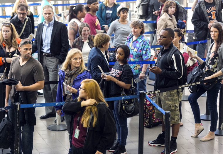 Travelers stand in line at Los Angeles International airport
