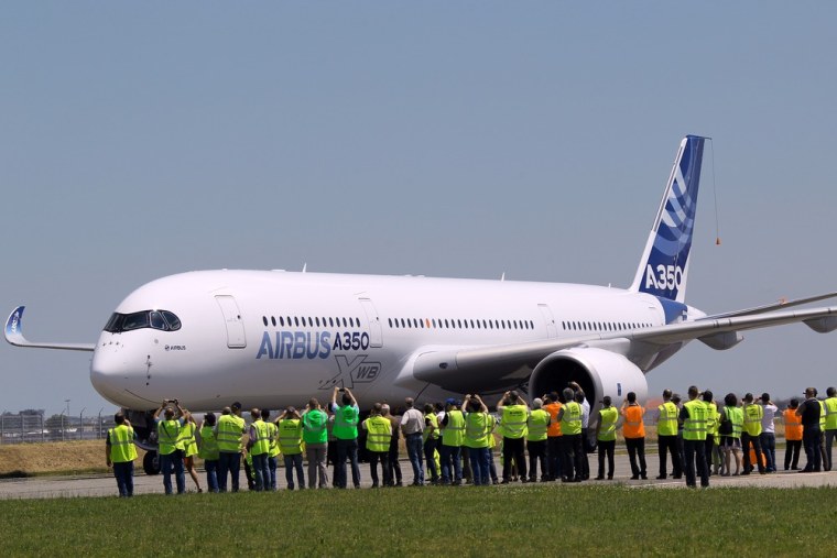 The Airbus A350 lands after its maiden flight at Blagnac airport near Toulouse, southwestern France, Friday, June 14, 2013.