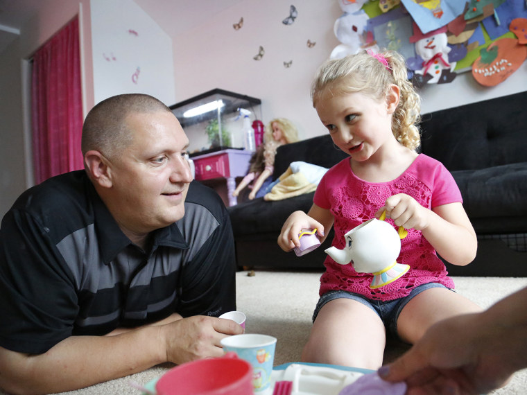 Carl Poff attends a tea party with his daughter Joselyn, 4, in their playroom. The girls love to have tea parties about once a week, Poff said.