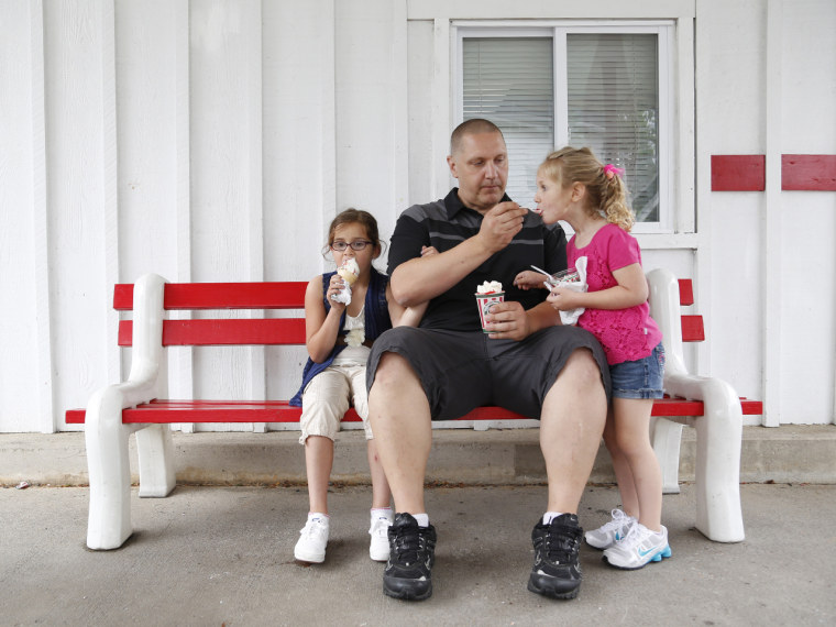 Carl Poff feeds his daughter Joselyn, 4, a bite of ice cream outside Rita's Italian Ice in Easton, Pa.