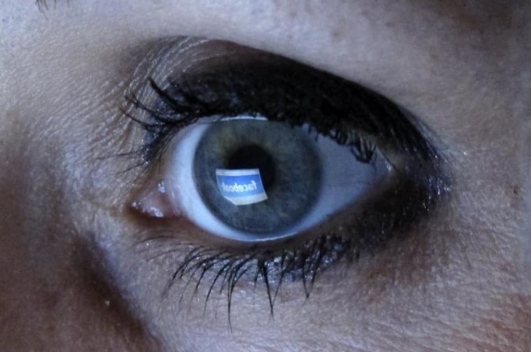 An illustration picture shows a woman looking at the Facebook website on a computer in Munich February 2, 2012. REUTERS/Michael Dalder