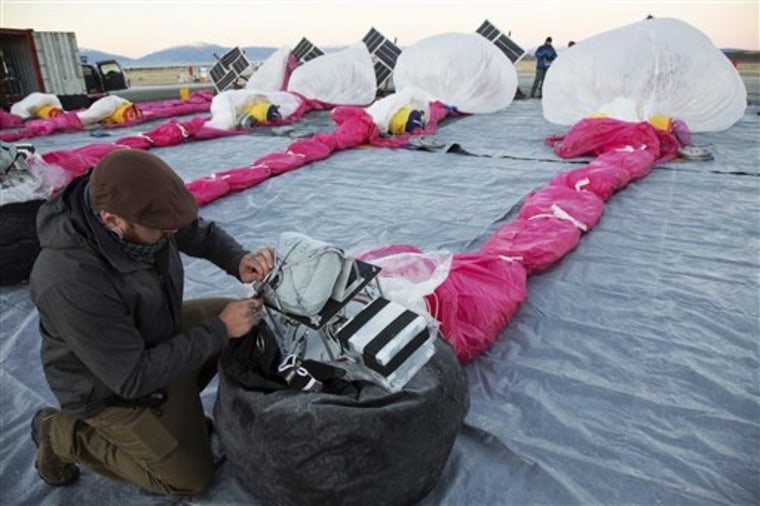 In this June 10, 2013 photo released by Google, Jordan Miceli prepares electronics to launch balloons in Tekapo, New Zealand. Google is testing the ba...