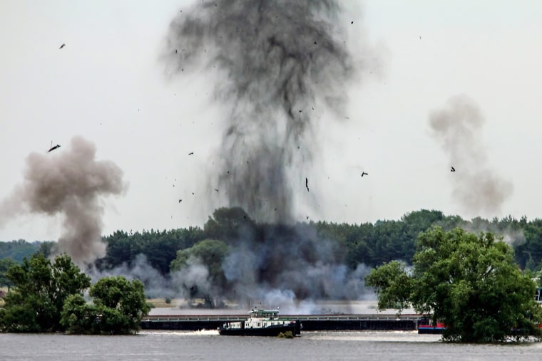 Smoke rises in the air after blasts that sunk two ships to close the gap in a broken dyke in Fischbeck, Germany on June 15. Germany's 16 state premiers agreed with federal officials on an $10.6 billion funding target for aid to repair buildings and farmland devastated this month by floods.