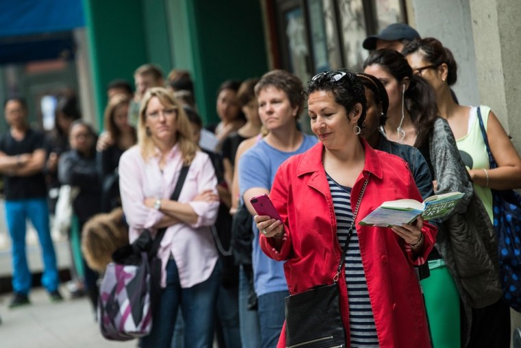 NEW YORK, NY - JUNE 10:  Allison Smith, on vacation from Minnesota, waits in line to purchase a croissant-doughnut hybrid (known as a \"cronut\") outsid...