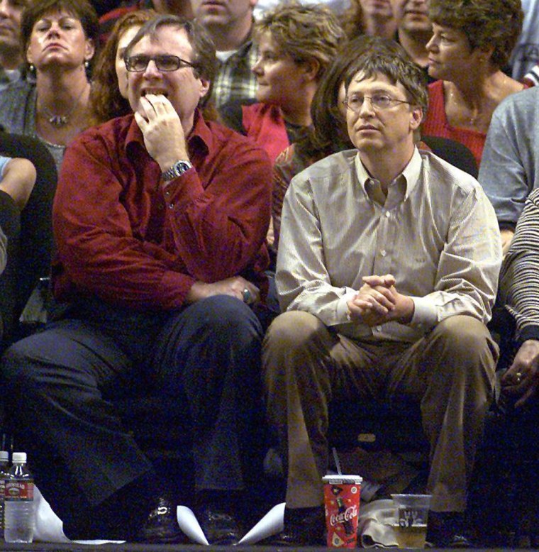 Microsoft co-founders Bill Gates (C) and Paul Allen (L) watches the third game of the Western Conference Finals between the Los Angeles Lakers and the...