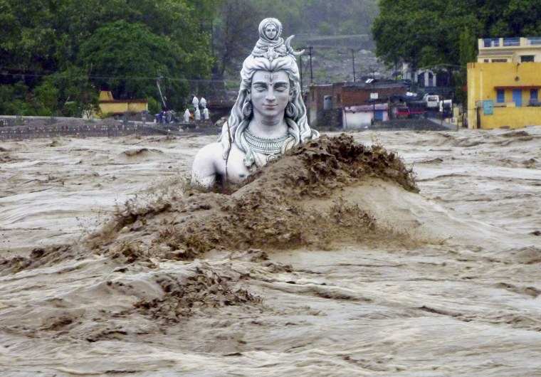 A submerged idol of Hindu Lord Shiva stands in the flooded River Ganges in Rishikesh, in the northern Indian state of Uttarakhand, India, on June 18, 2013. Monsoon torrential rains have cause havoc in northern India leading to flash floods, cloudbursts and landslides as the death toll continues to climb and more than 1,000 pilgrims bound for Himalayan shrines remain stranded.