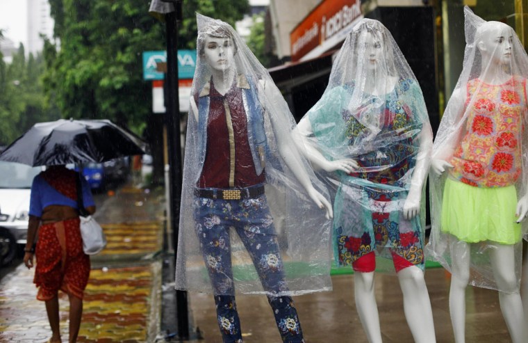 Mannequins are covered with plastic as it rains in Mumbai, India, on June 18, 2013. The monsoon rains which usually hit India from June to September are crucial for farmers whose crops feed hundreds of millions of people.