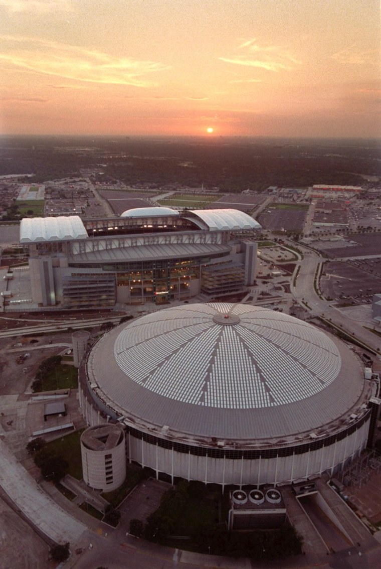 FILE - In this Aug. 2, 2002 file photo, an aerial view of Reliant Stadium, top, the new home of the Houston Texans and the Astrodome, bottom, former h...