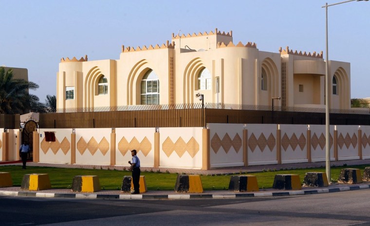 A security guard stands outside the Afghan Taliban Political Office after the official opening, in Doha, Qatar, Tuesday.