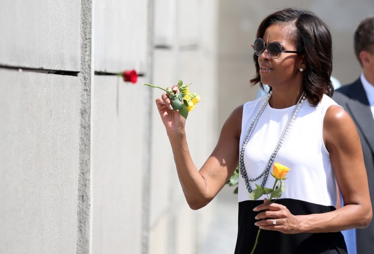 Michelle Obama lays flowers at the Berlin Wall memorial in Bernauer Street.