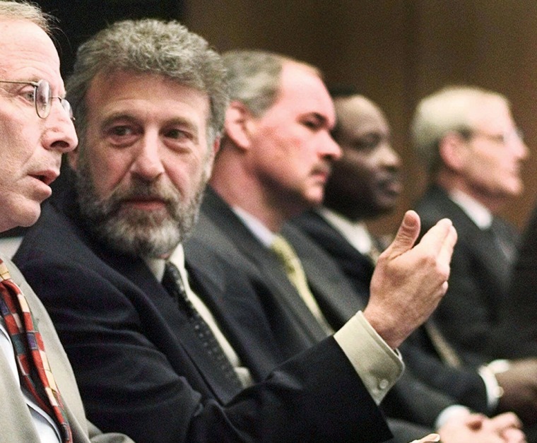 FILE - In this Thursday, May 6, 1999 file photo, George Zimmer, second from left, gestures to Andy Dolich prior to a meeting, in Oakland, Calif. Men's...