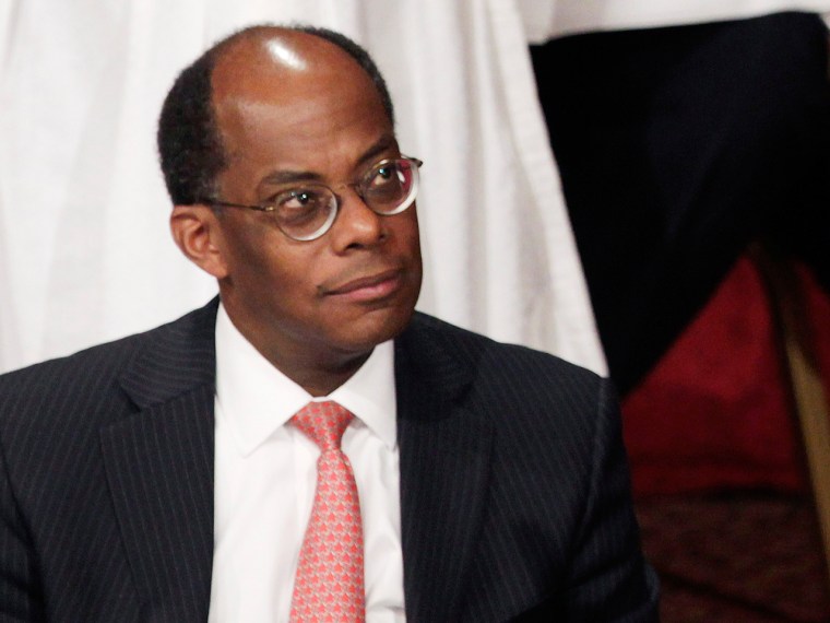 Roger Ferguson, Jr. listens to Christine Lagarde, not seen, speak on April 10, 2013, in New York.