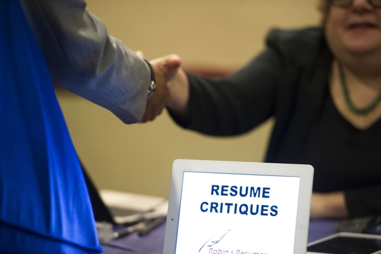 In this Thursday, May 30, 3013 photo, a job seeker stops at a table offering resume critiques during a job fair held in Atlanta.