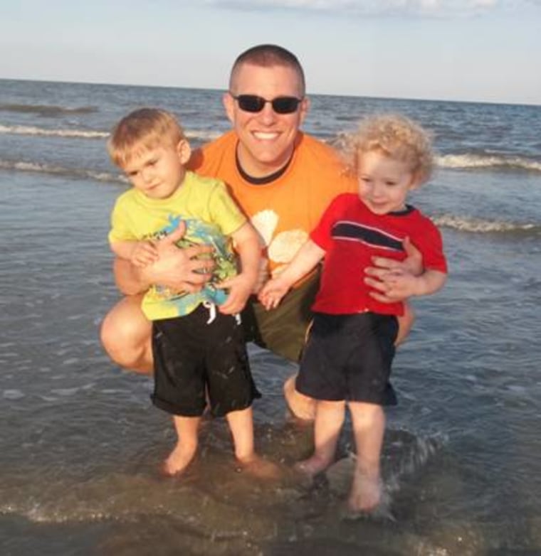 Len Clamp hugs his boys, Grayson and Ethan, in an undated photo.