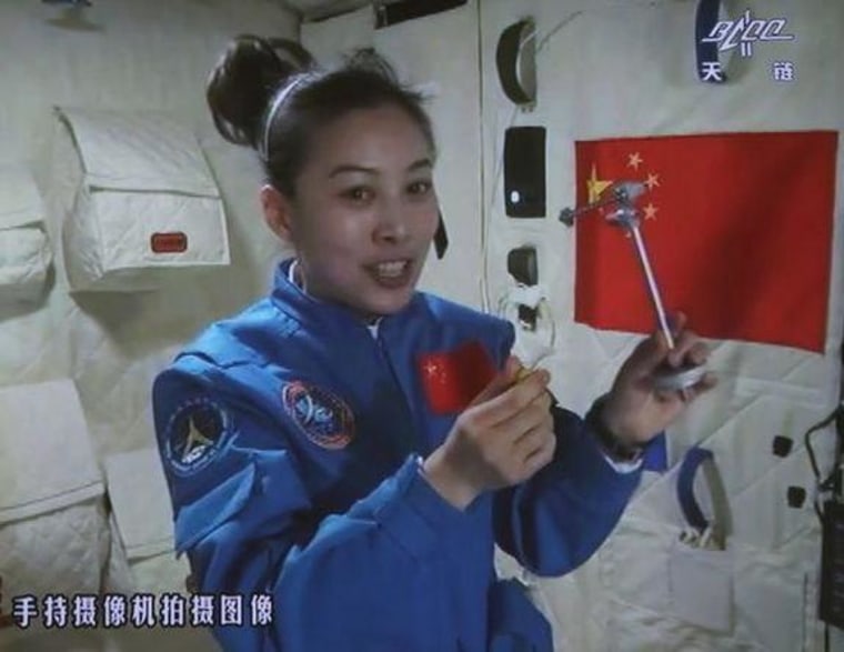 Astronaut Wang Yaping gives a lecture to students on Earth from aboard the Tiangong-1 in this television screen-grab..
