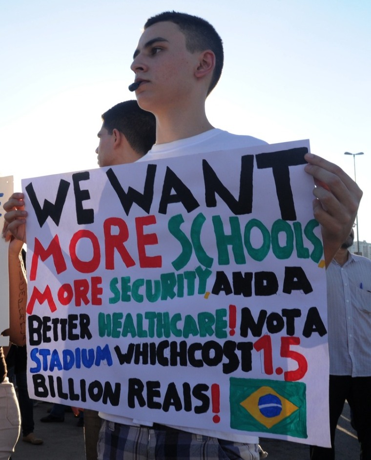 Students hold signs during a protest of what is now called the 'Tropical Spring' against corruption and price hikes, at National Congress in Brasilia, on June 20, 2013.