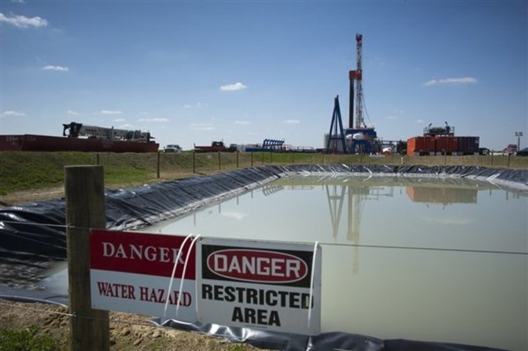 In this file photo, a fracking fluid pit sits next to a drill site near Waynesburg, Pa.